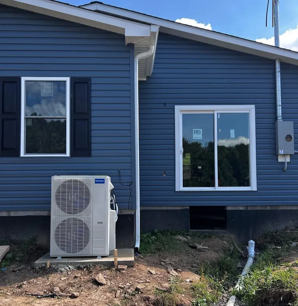 Ductless mini-split condenser on a home exterior